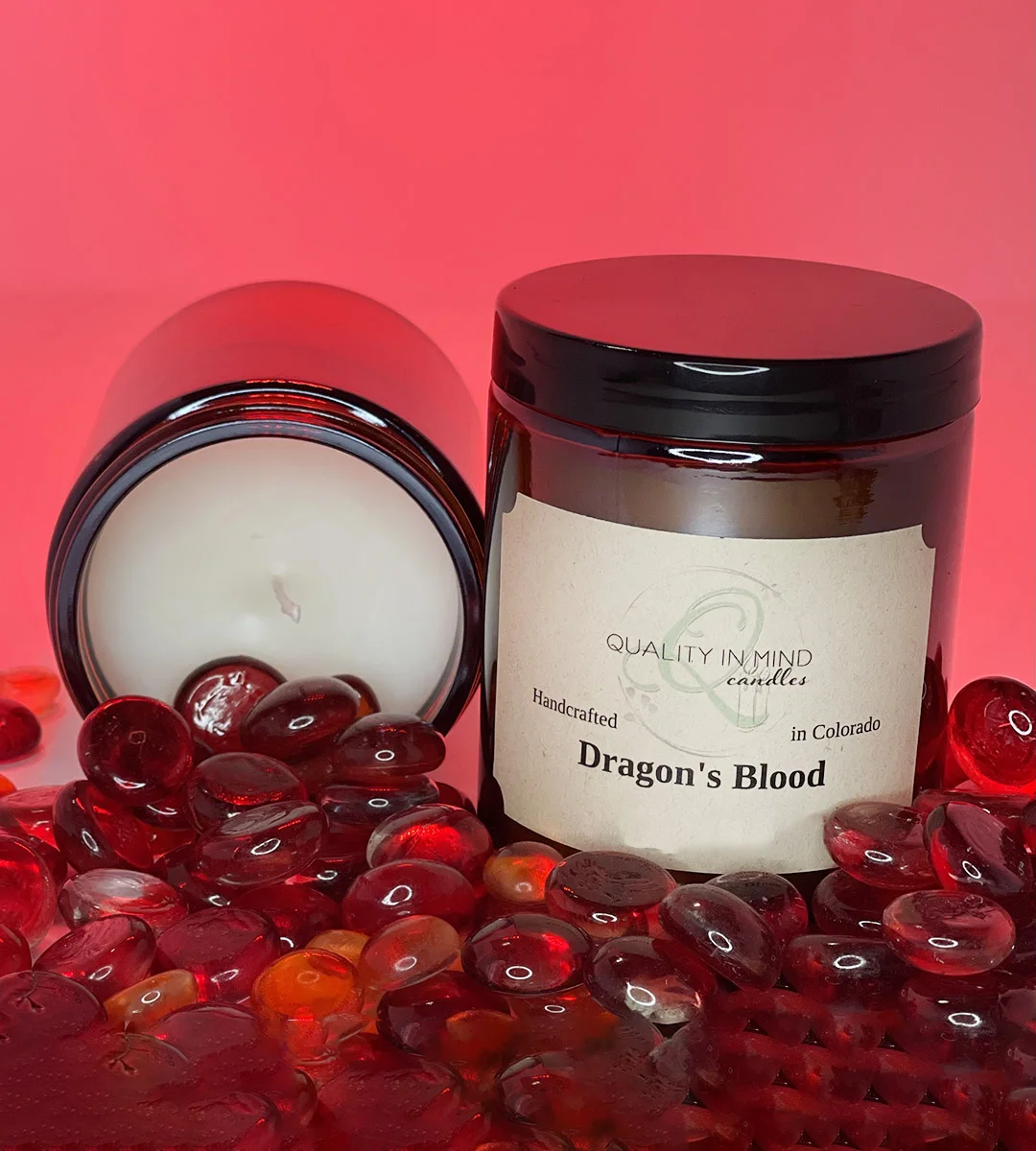 Candle in Dragon's Blood Scent surrounded by red stones